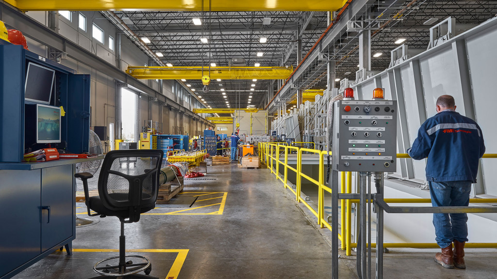 A person standing in a factory.