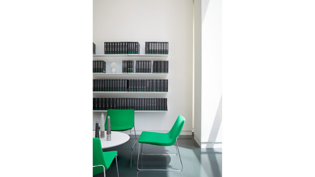 A room with a table chairs and shelves.