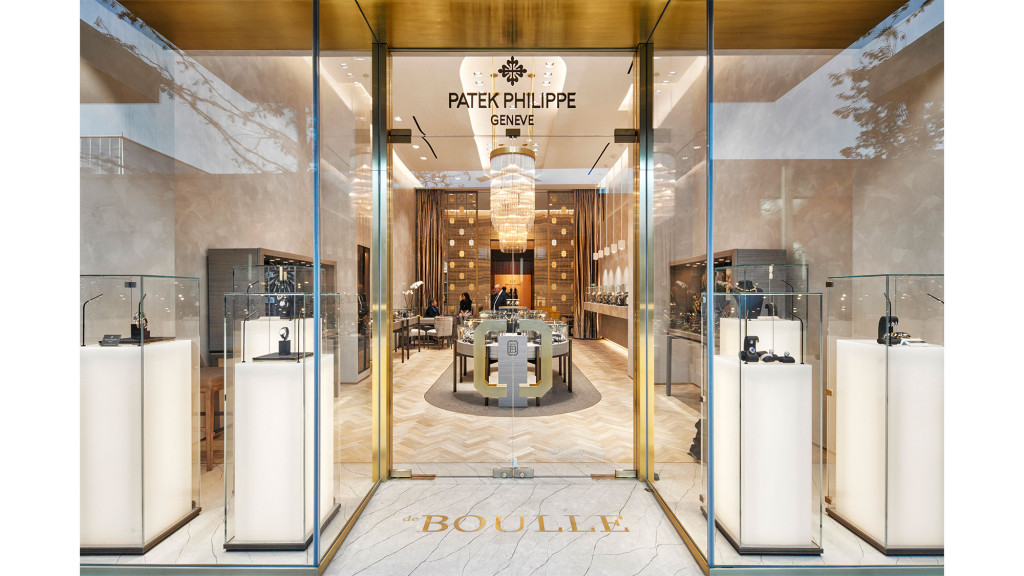 A long hallway with several cubicles.