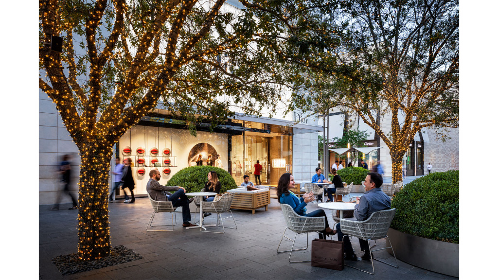 A group of people sitting at a table outside.
