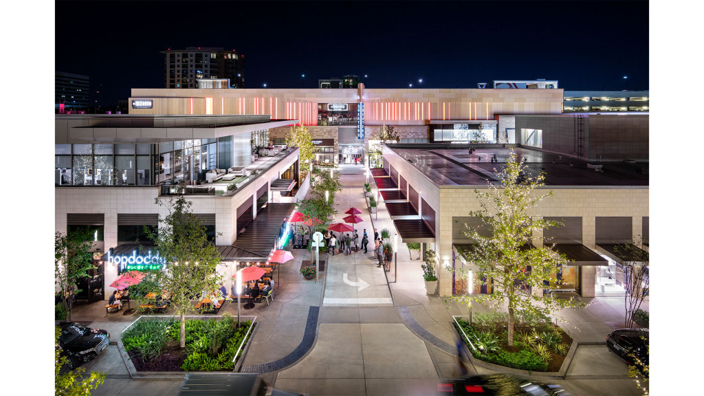 A courtyard with buildings and people.
