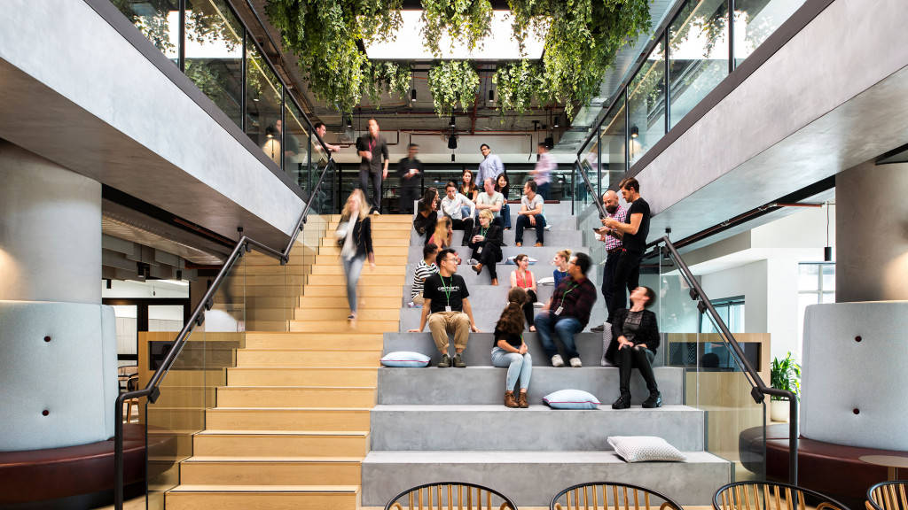 A group of people sitting on stairs.