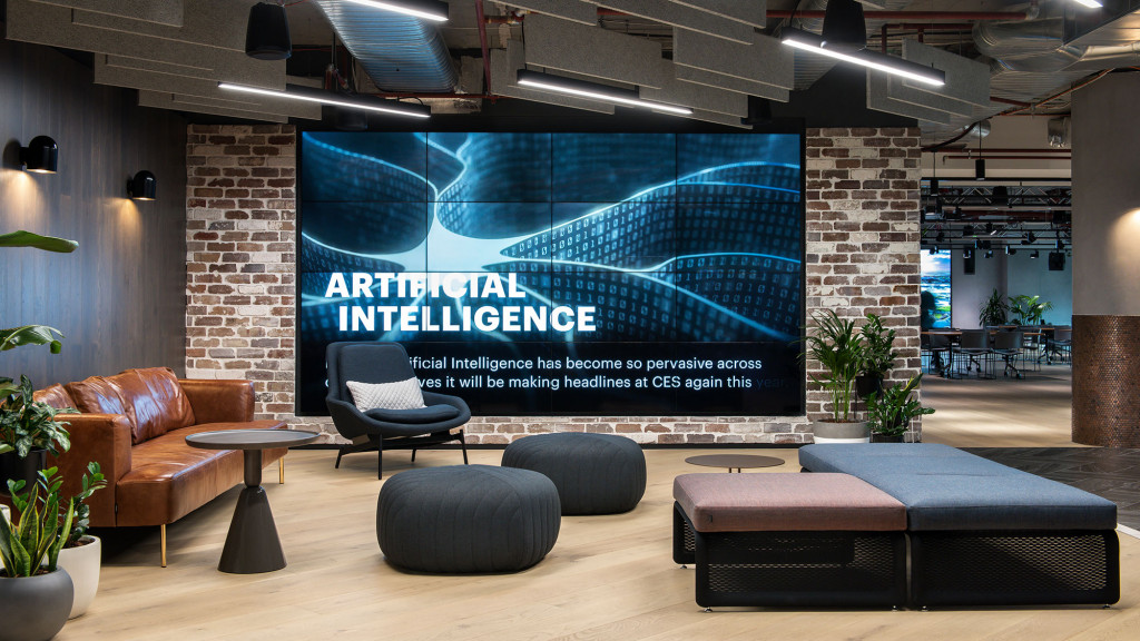 A room with a screen and chairs.