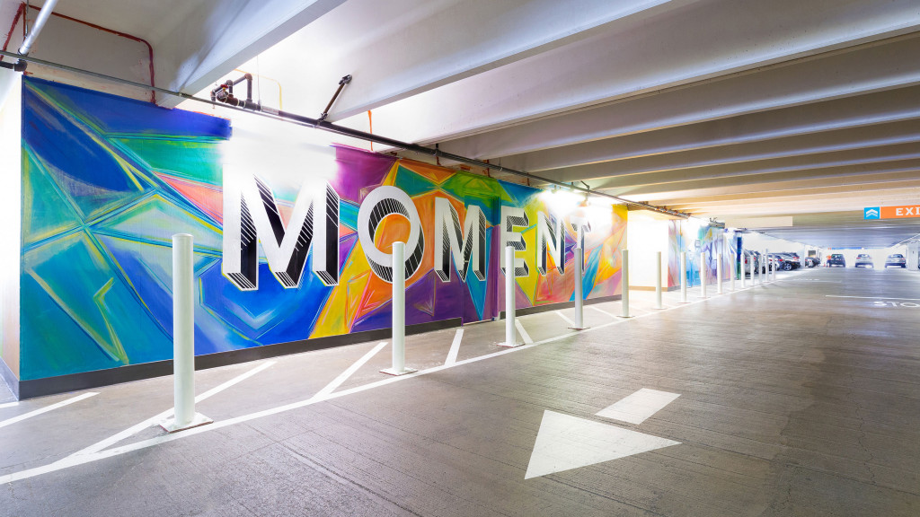 A road with a wall of graffiti.