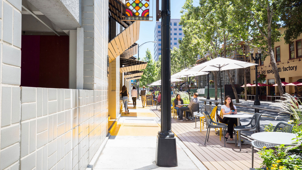 People sitting at tables outside.