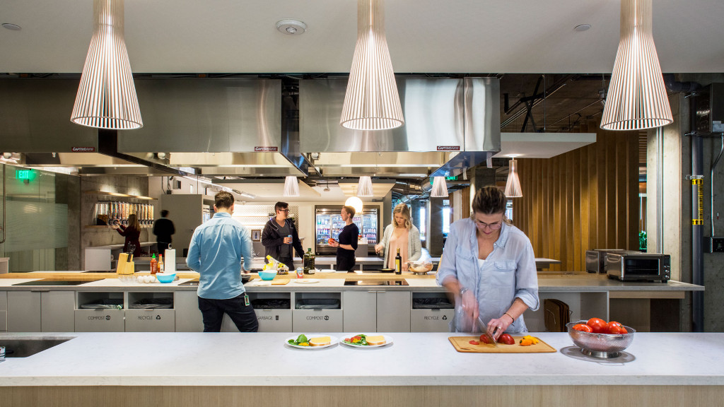 A group of people in a kitchen.