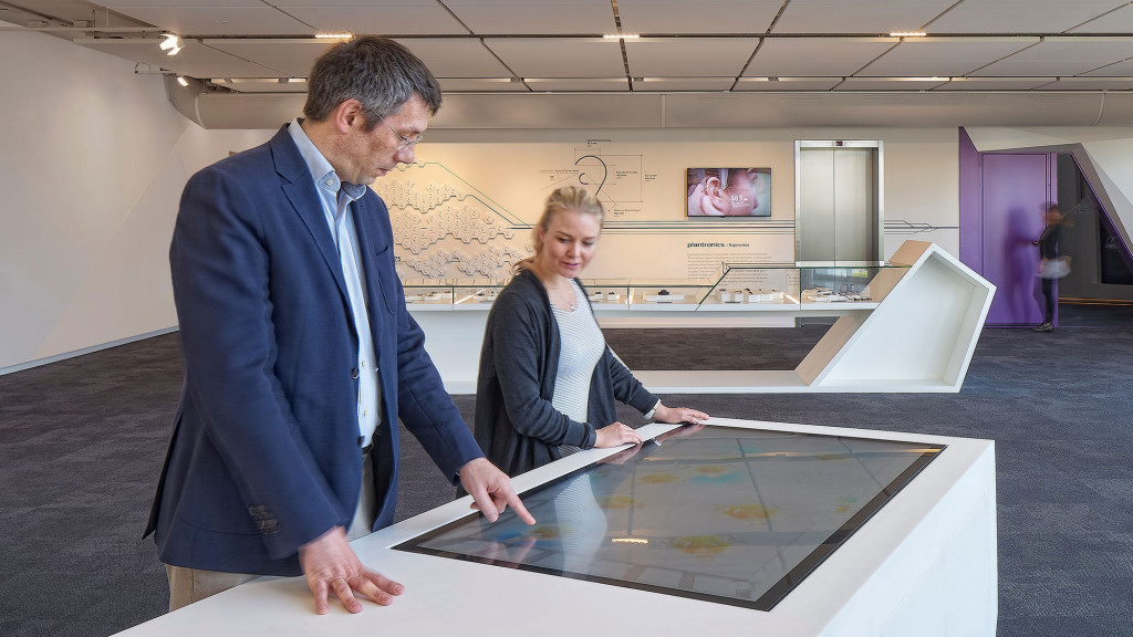 A man and a woman looking at a piece of paper.