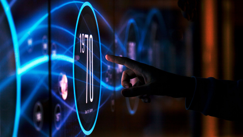 A hand pointing at a screen.