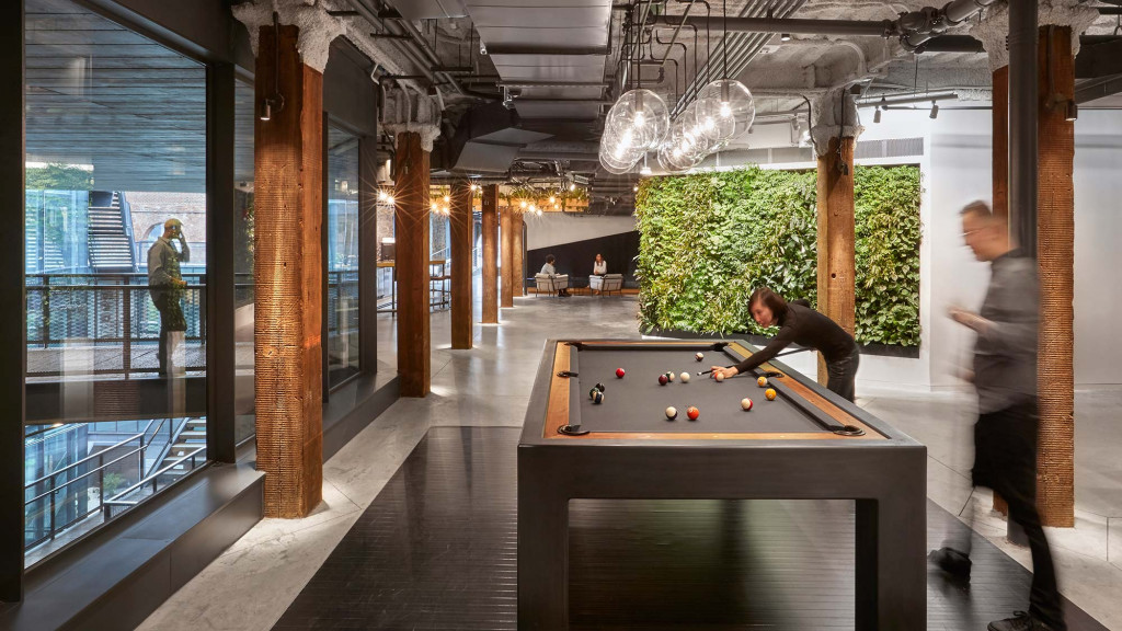 A person playing pool in a room.