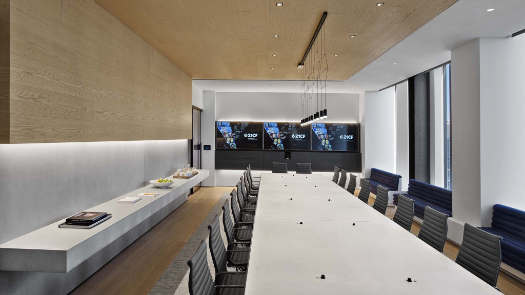 A large conference room with a large table and chairs.