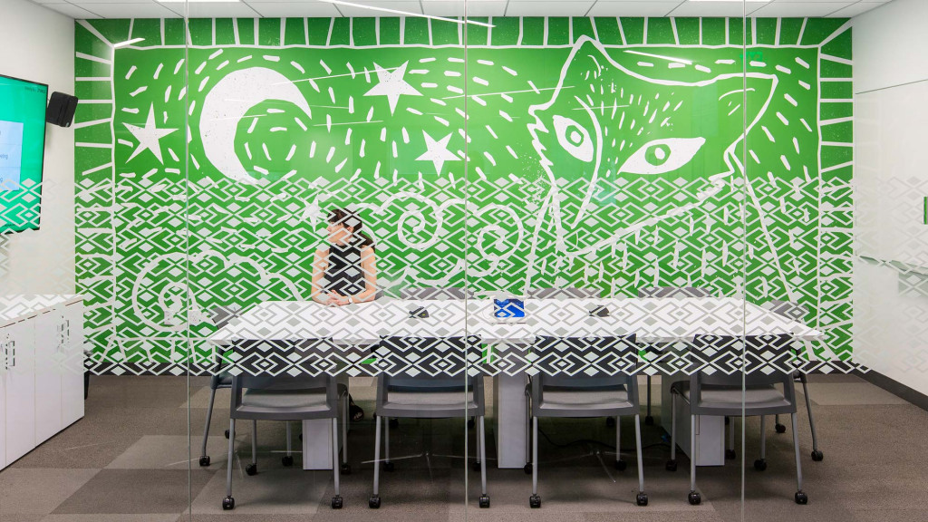 A table with chairs and a chalkboard in the background.