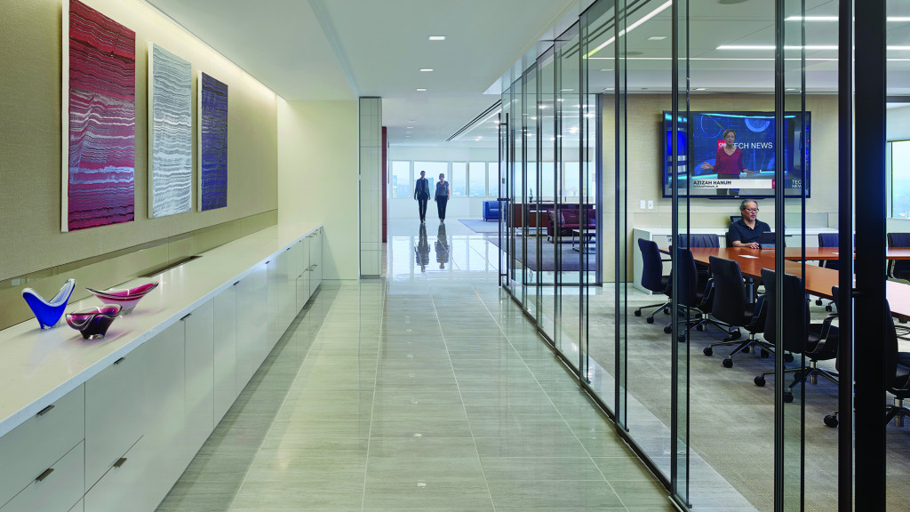 A long hallway with people and computers.