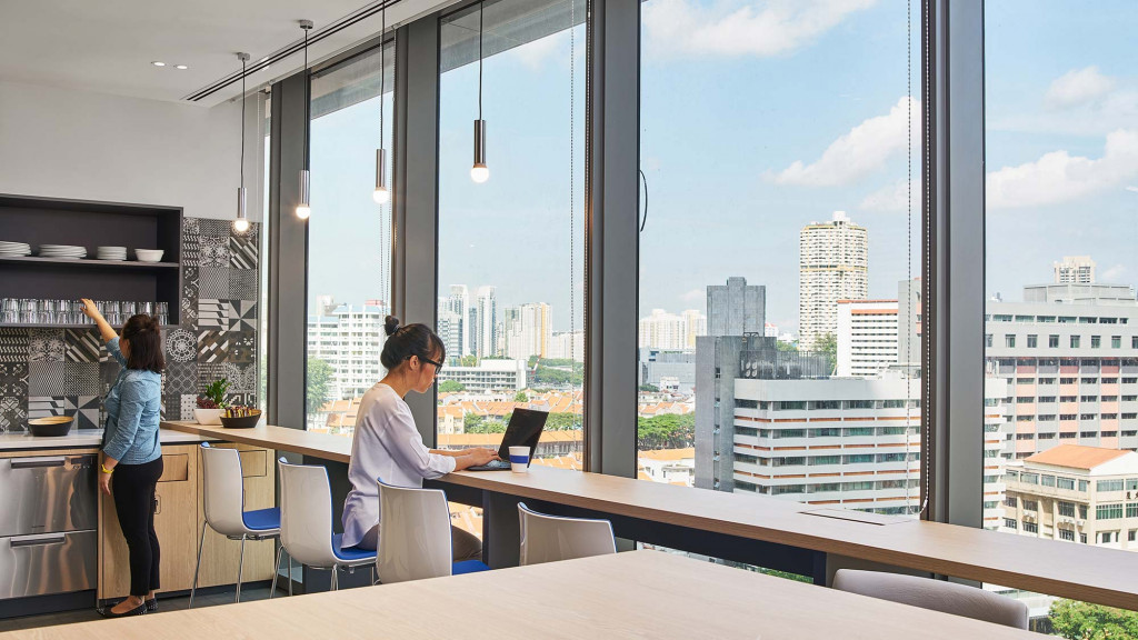A woman and a man looking at a laptop.