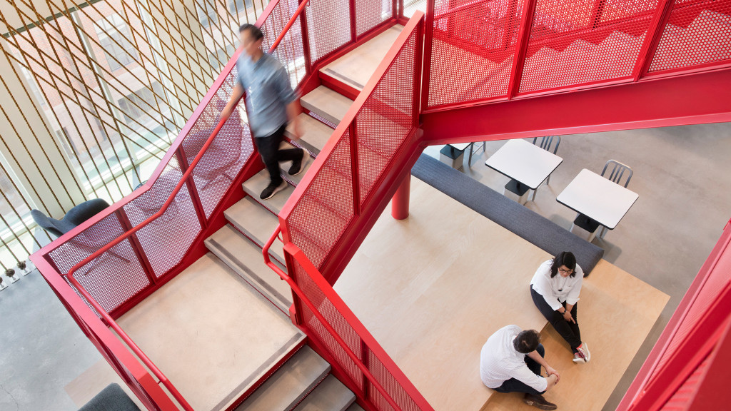 People sitting on a red floor.