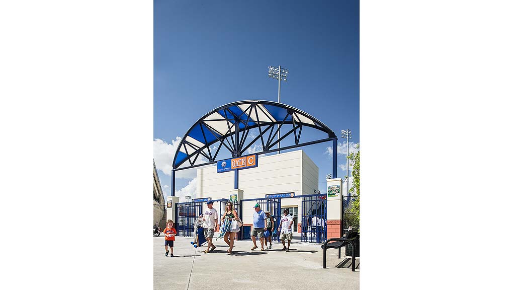 A group of people walking outside of a building.
