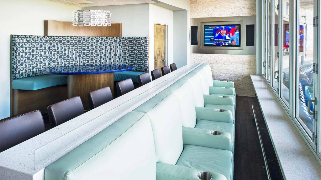 A room with a tv and chairs.