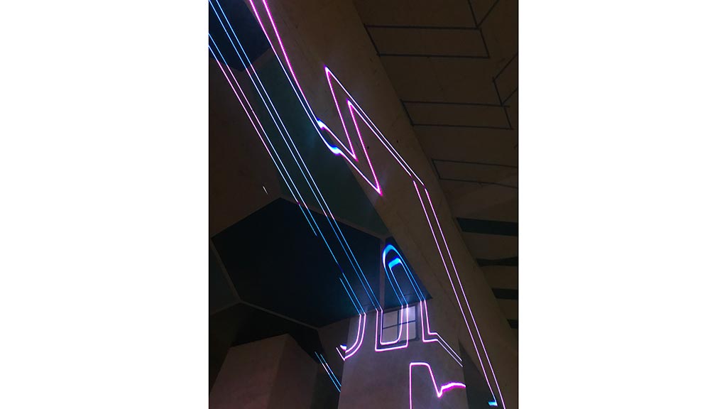A neon sign with purple lights.