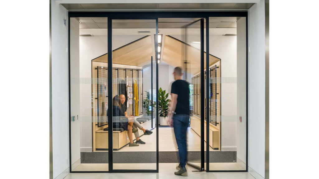 A man and a woman in a glass doorway.