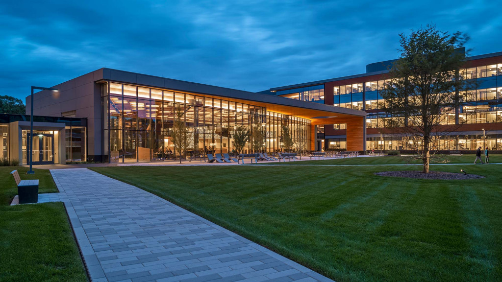 A building with a walkway and grass.