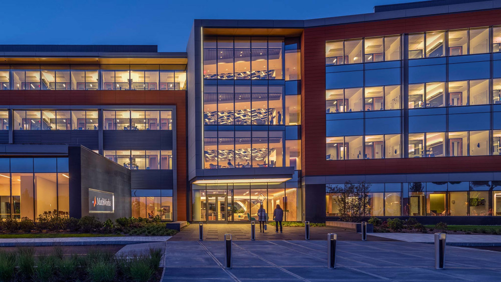 A building with windows and people walking by it.