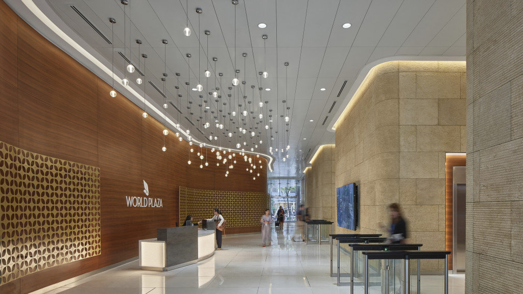 A large room with a table and people in it.