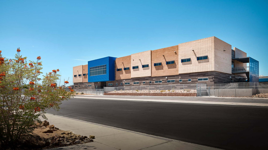 A large building with a parking lot.