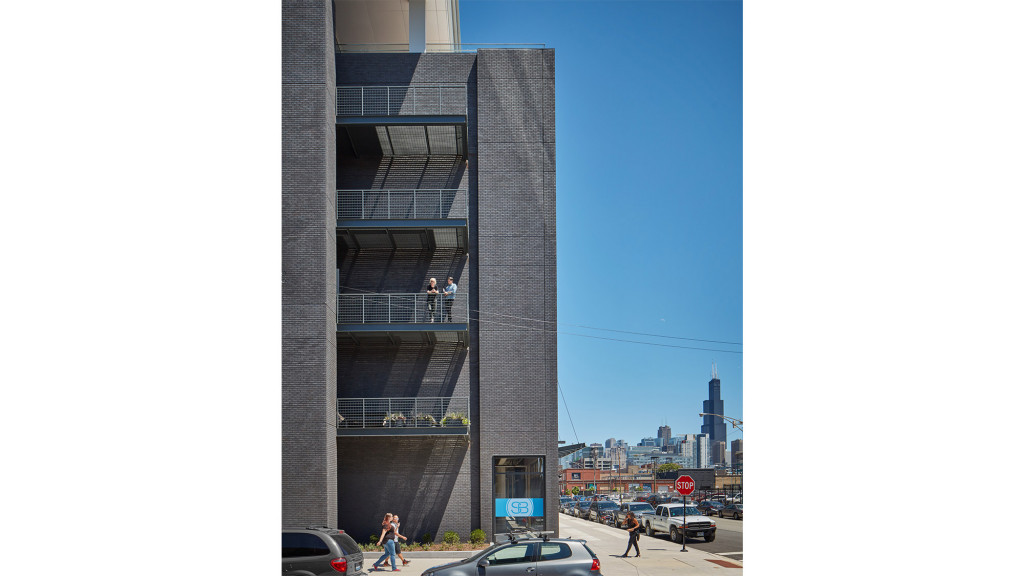 A tall building with people walking around.