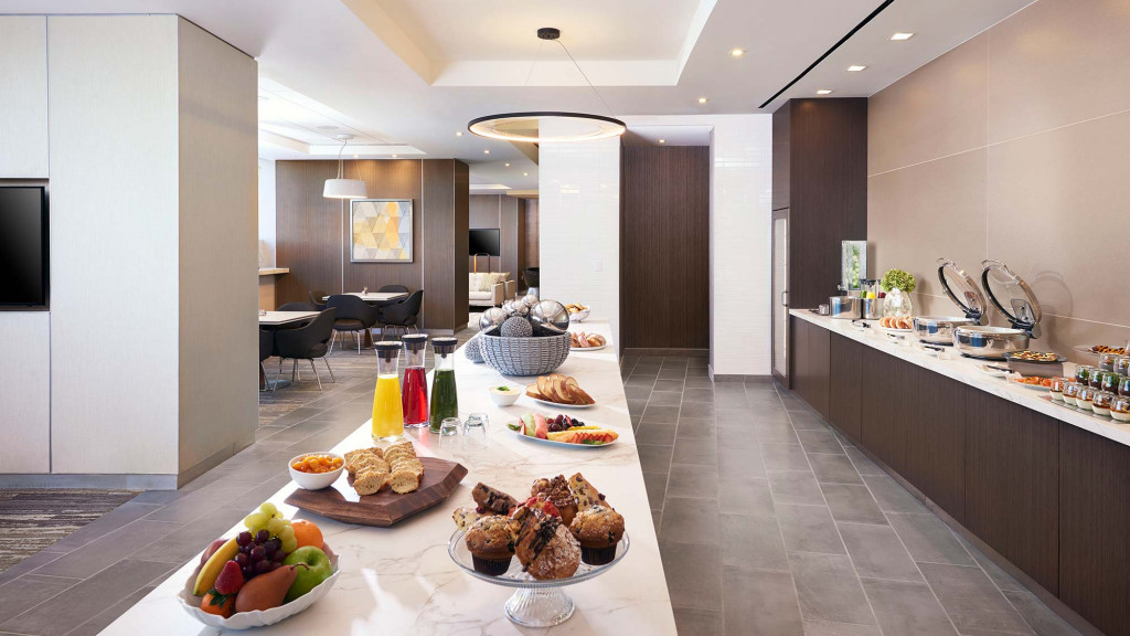 A kitchen with a table with food on it.