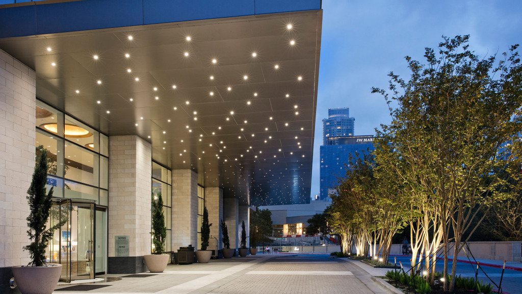 A building with a walkway and trees.