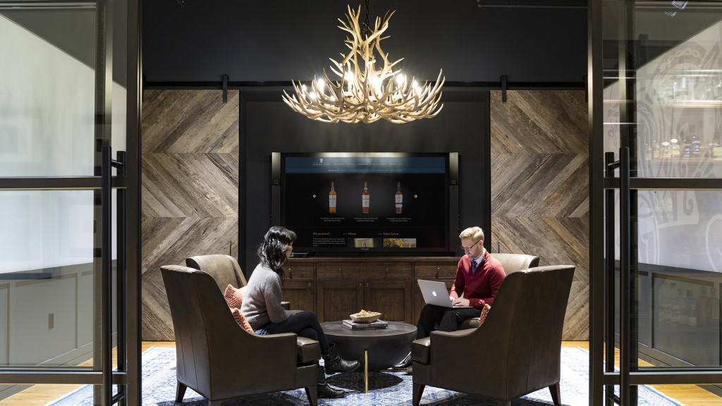 A man and woman sitting in chairs in a living room.