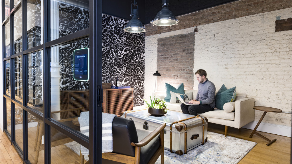 A person sitting on a couch with a laptop.