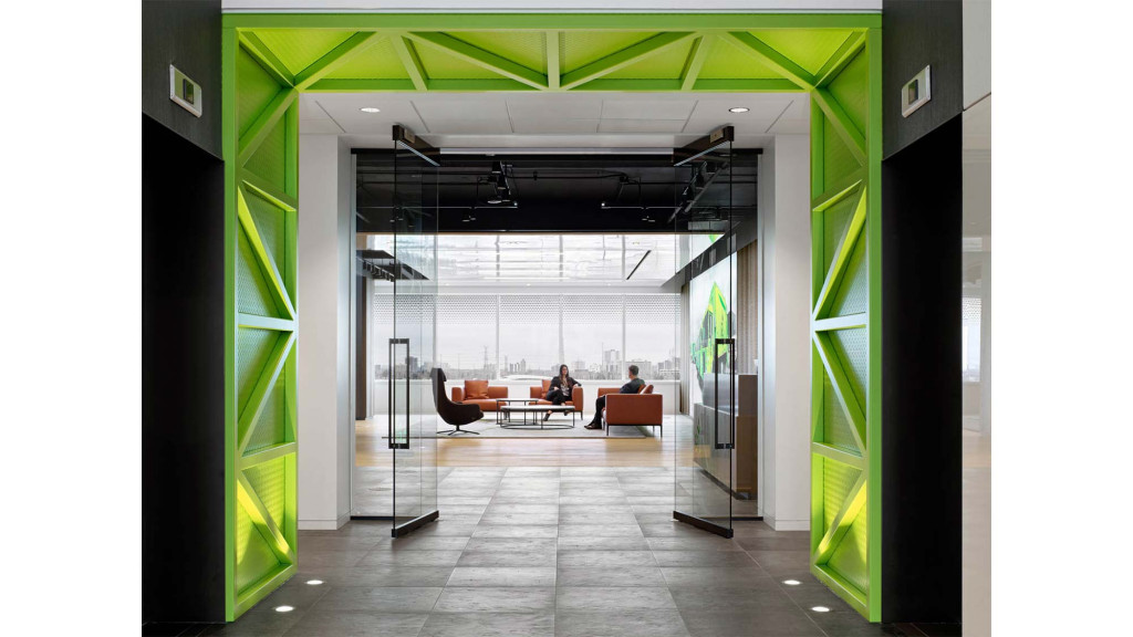 A couple of people sitting at a table in a room with green walls.