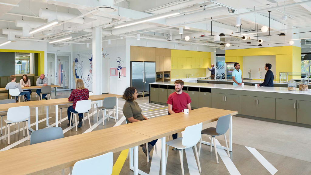 A group of people sitting at tables.
