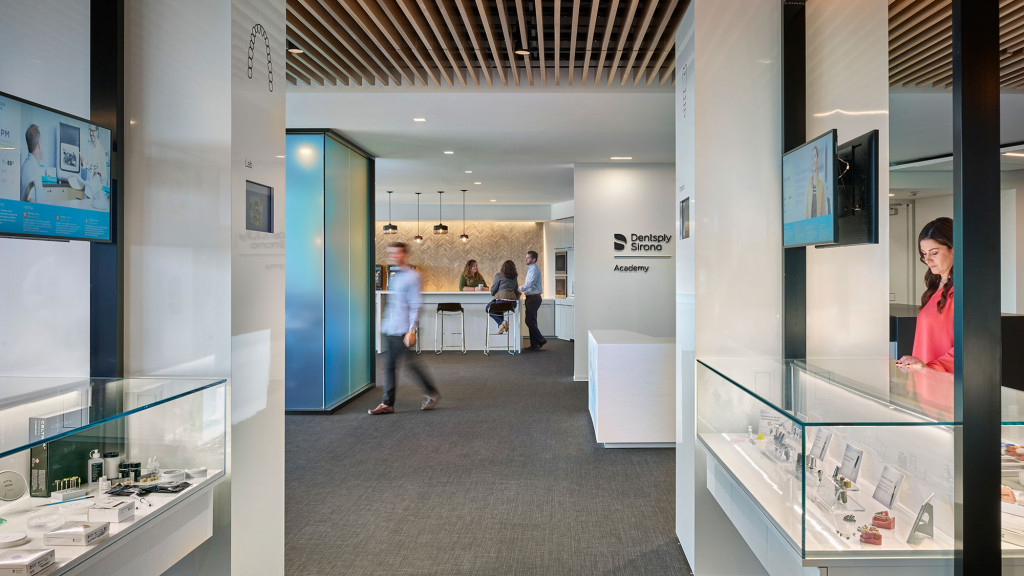 People in a room with glass walls.