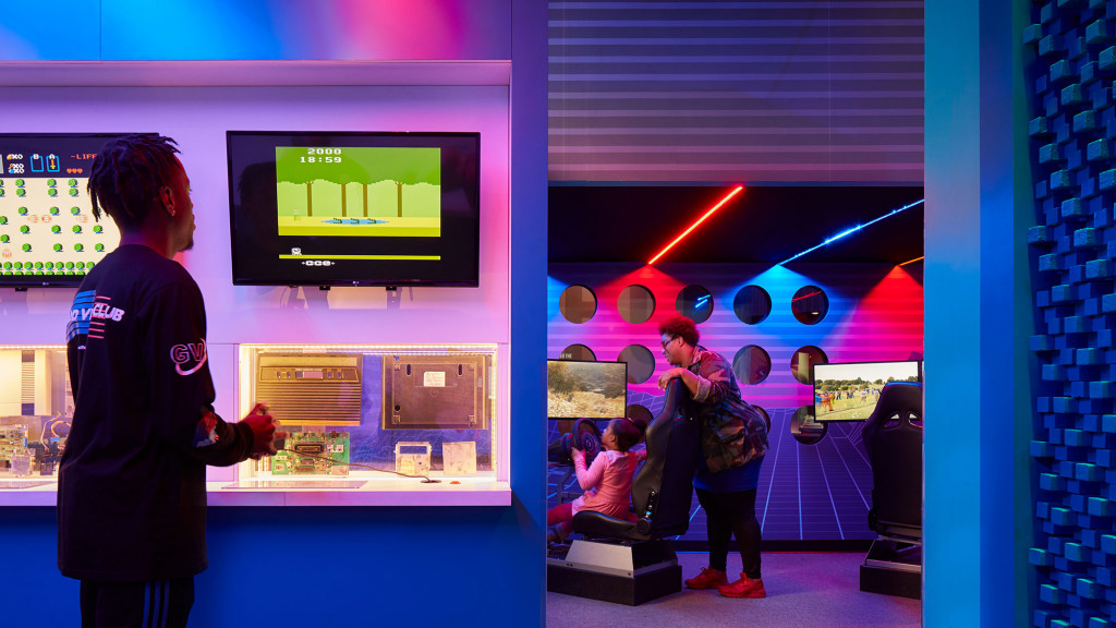 A person standing in front of a display of televisions.
