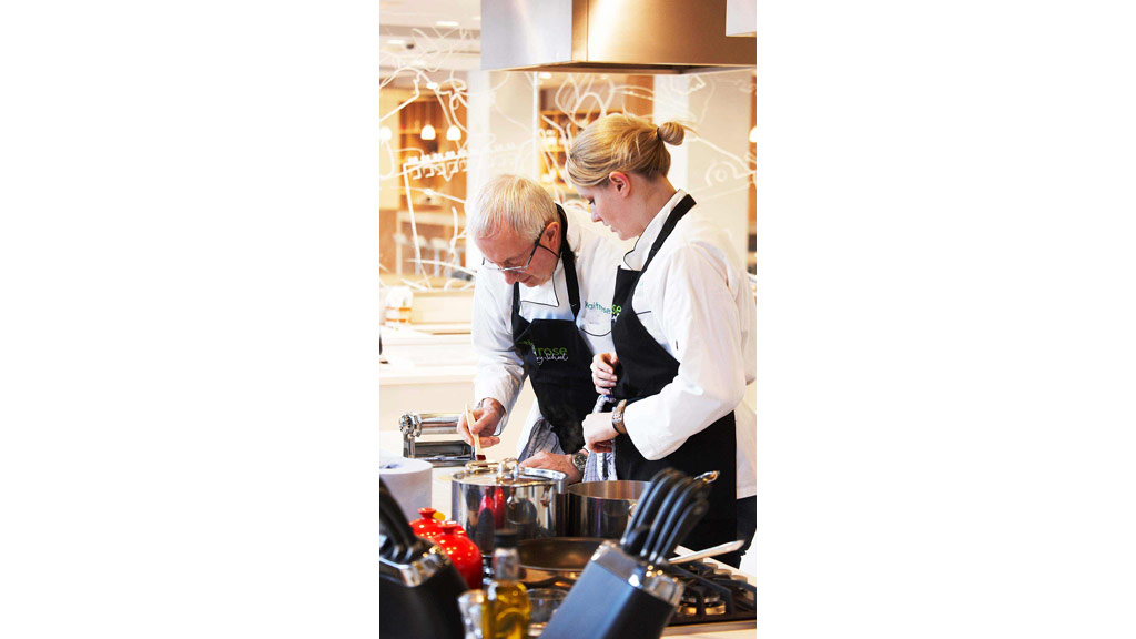 A couple of chefs in a kitchen.
