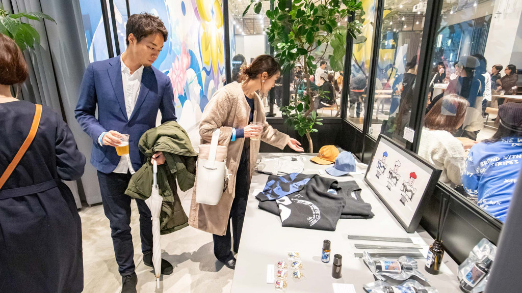 A group of people looking at a display of clothing.