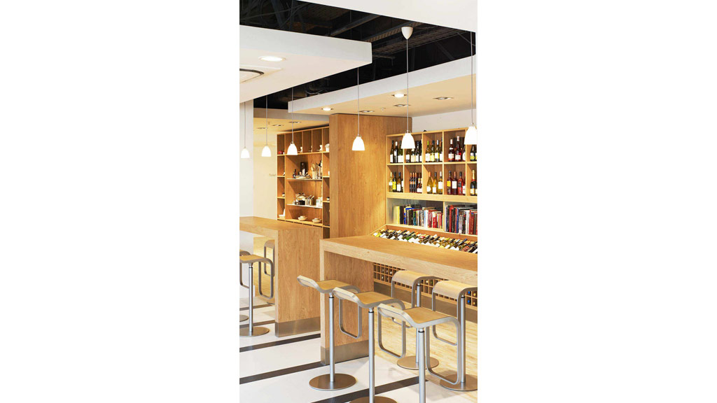 A room with a bar and stools.