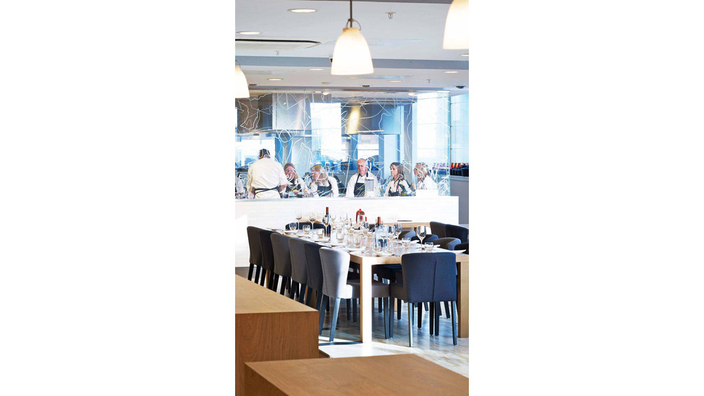 A group of people sitting at a table with drinks on it.