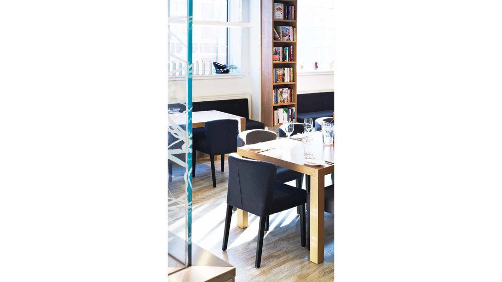 A table with chairs and a window.