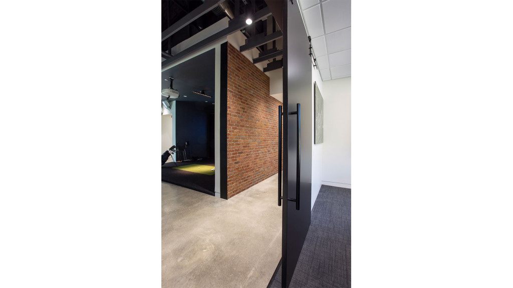 A hallway with a door and a window.