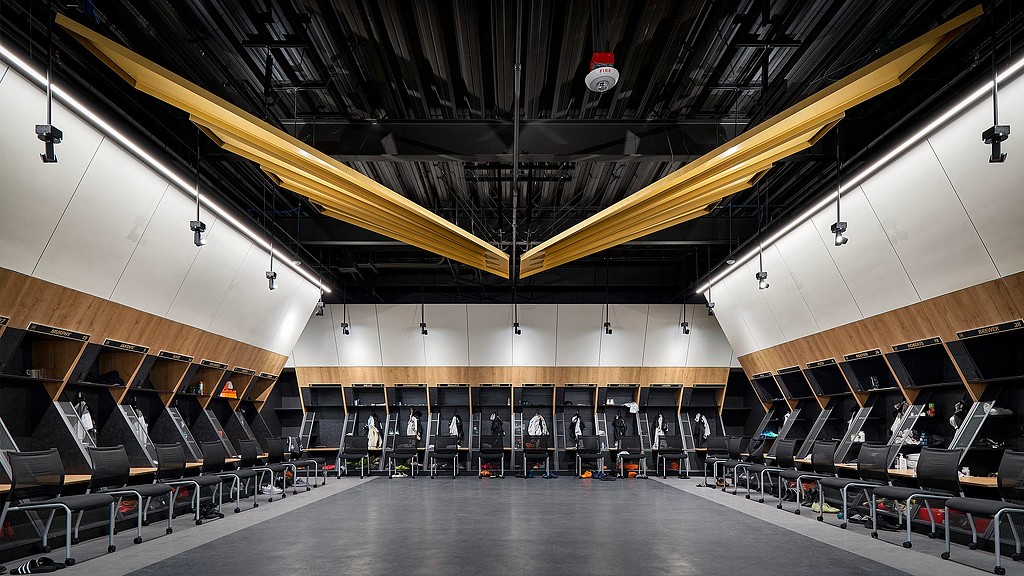 A large room with a few people.