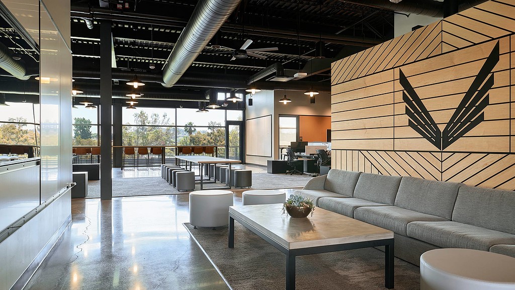 A modern looking living room with a large glass wall.