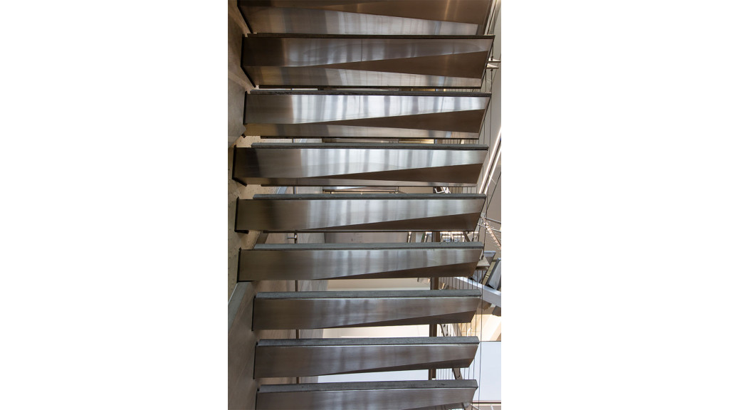 A wooden shelf with many books.