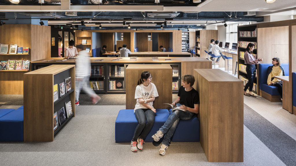 A group of people sitting in a library.