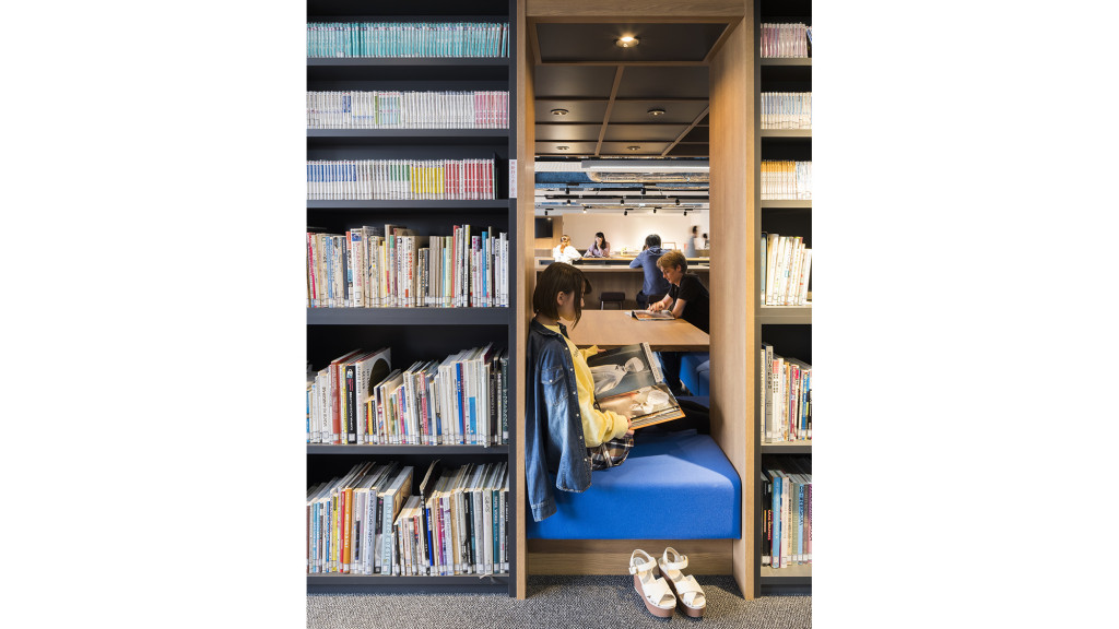 A room with bookshelves and a bed.
