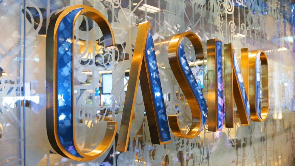 A group of scissors are in a glass case.