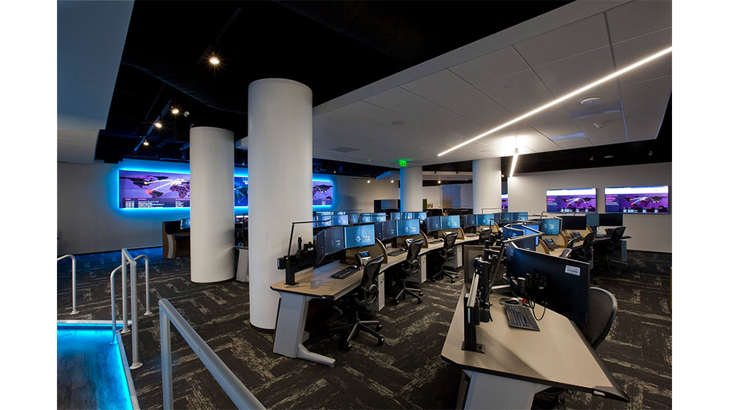 A room with computers and chairs.