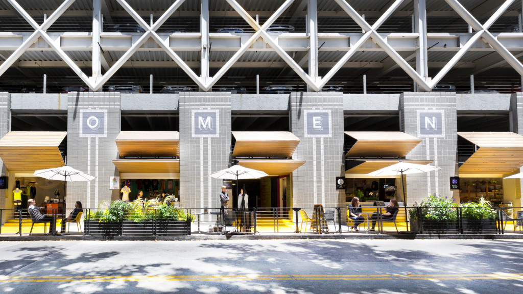 A group of people sitting outside a building.