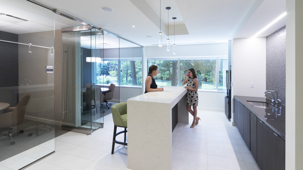 A person standing next to a counter.